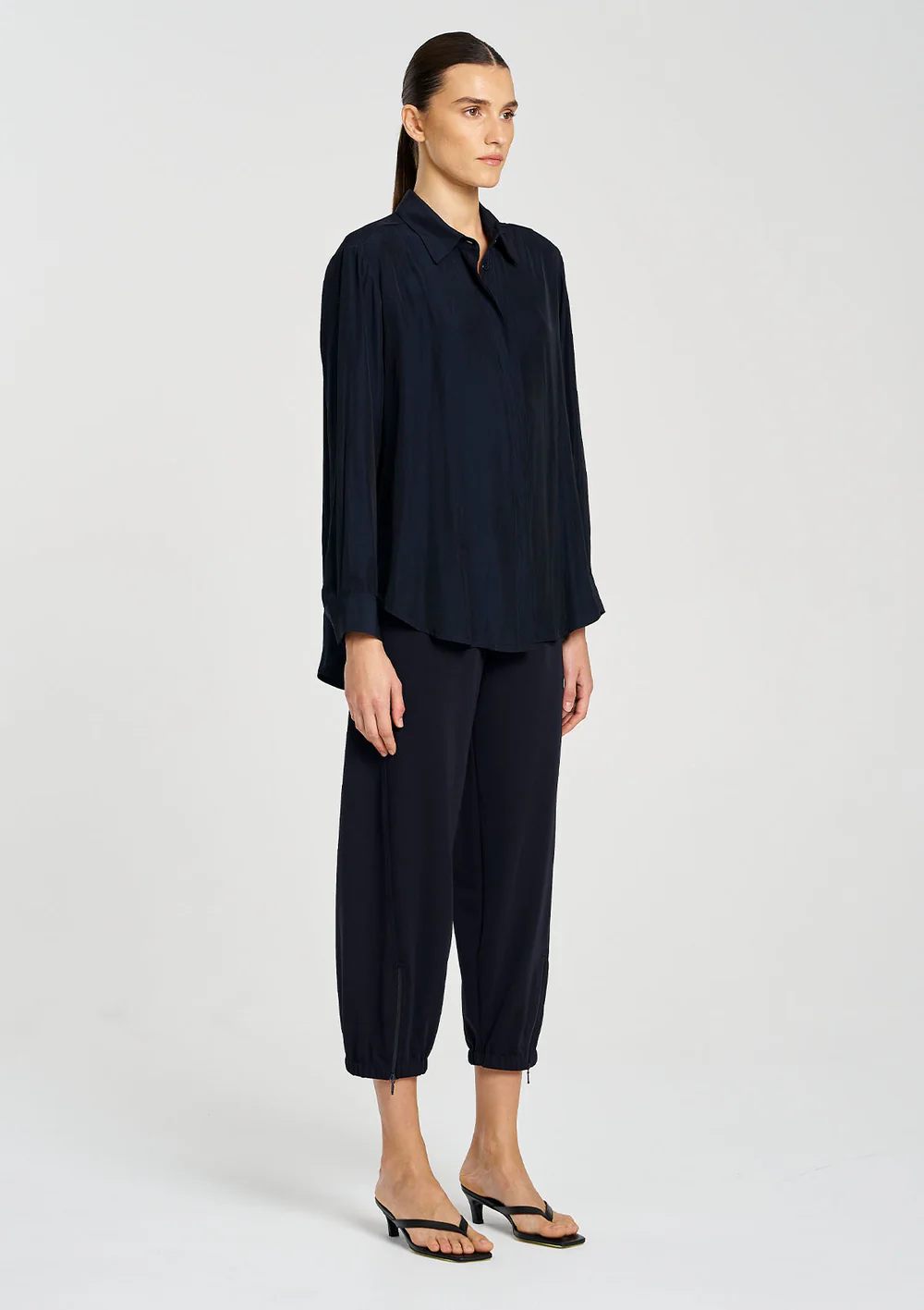 Person wearing a black outfit on a white background