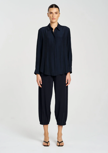 Woman wearing a navy blue outfit on a white background