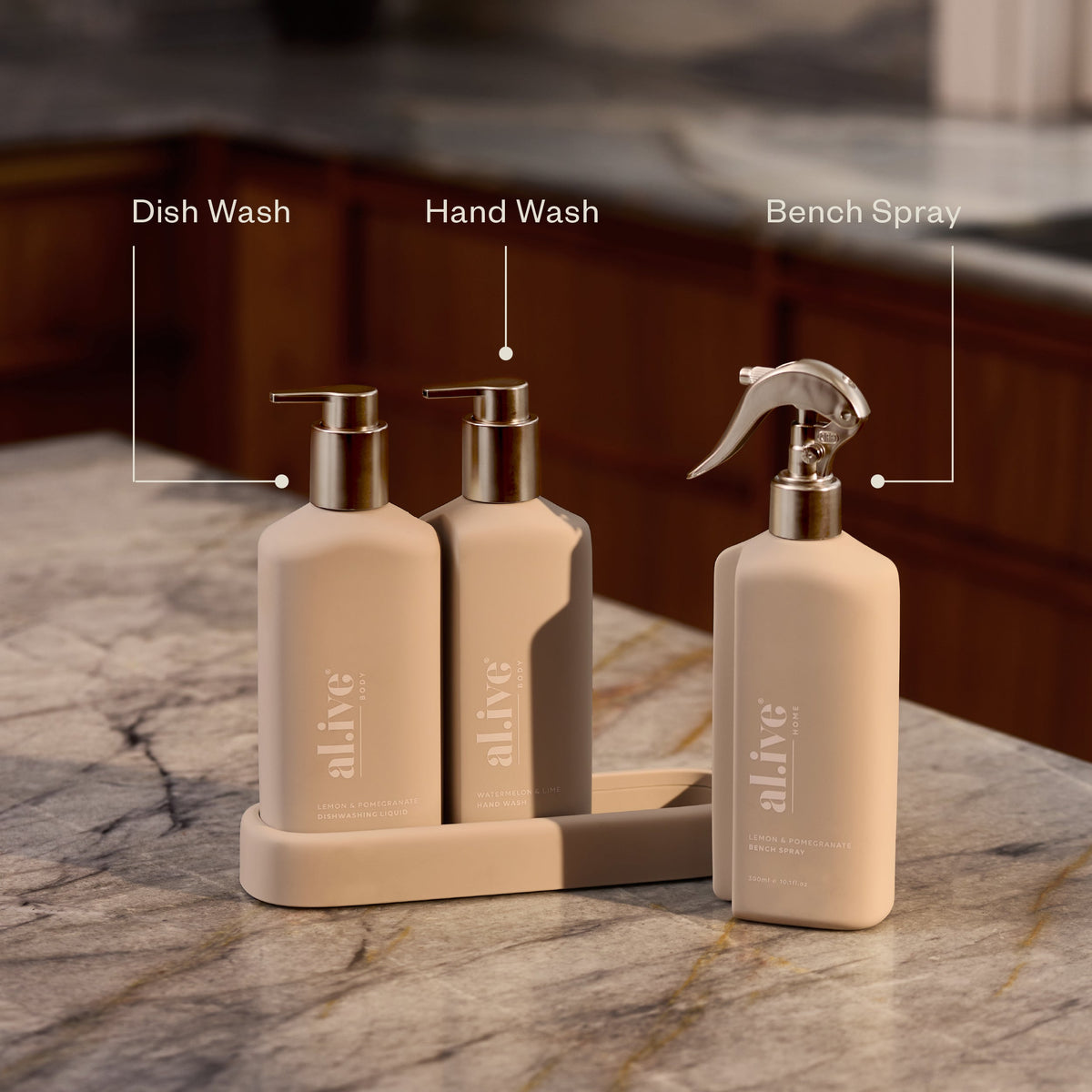 al.ive body Kitchen Trio Bronze Edition showing the dish wash, hand wash and bench spray on a marble kitchen bench