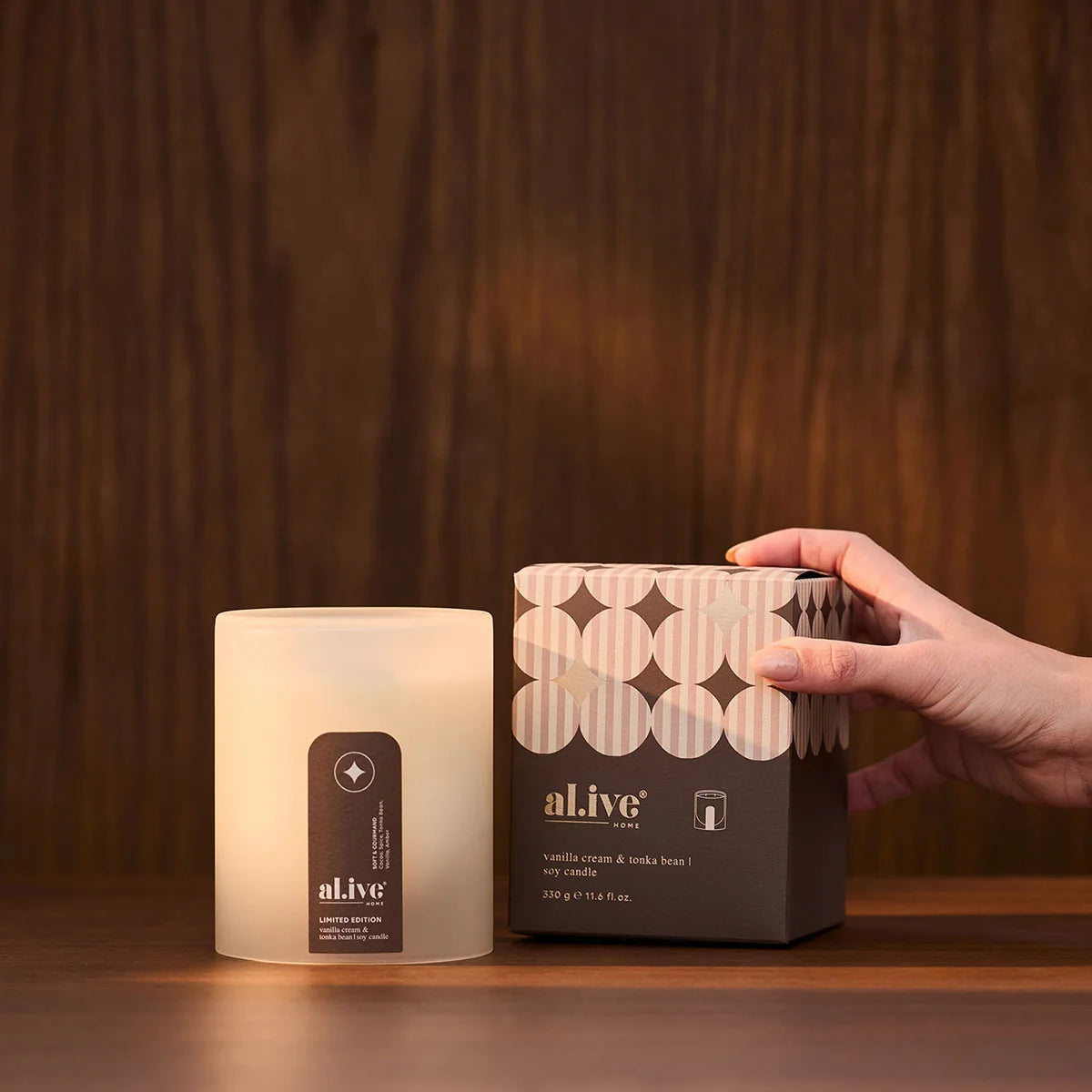 al.ive body Limited Edition Soy Candle placed beside its festive gift box