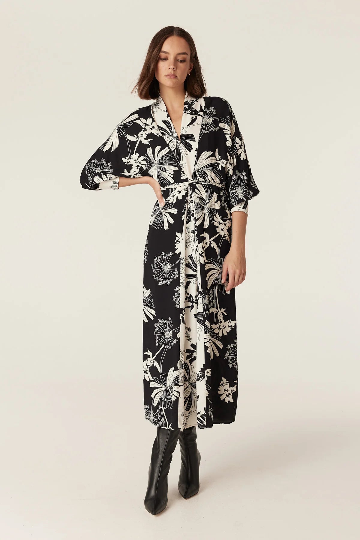 Woman wearing the Cable Melbourne Rita Midi Dress in Deco Print with batwing sleeves and a wraparound waist tie