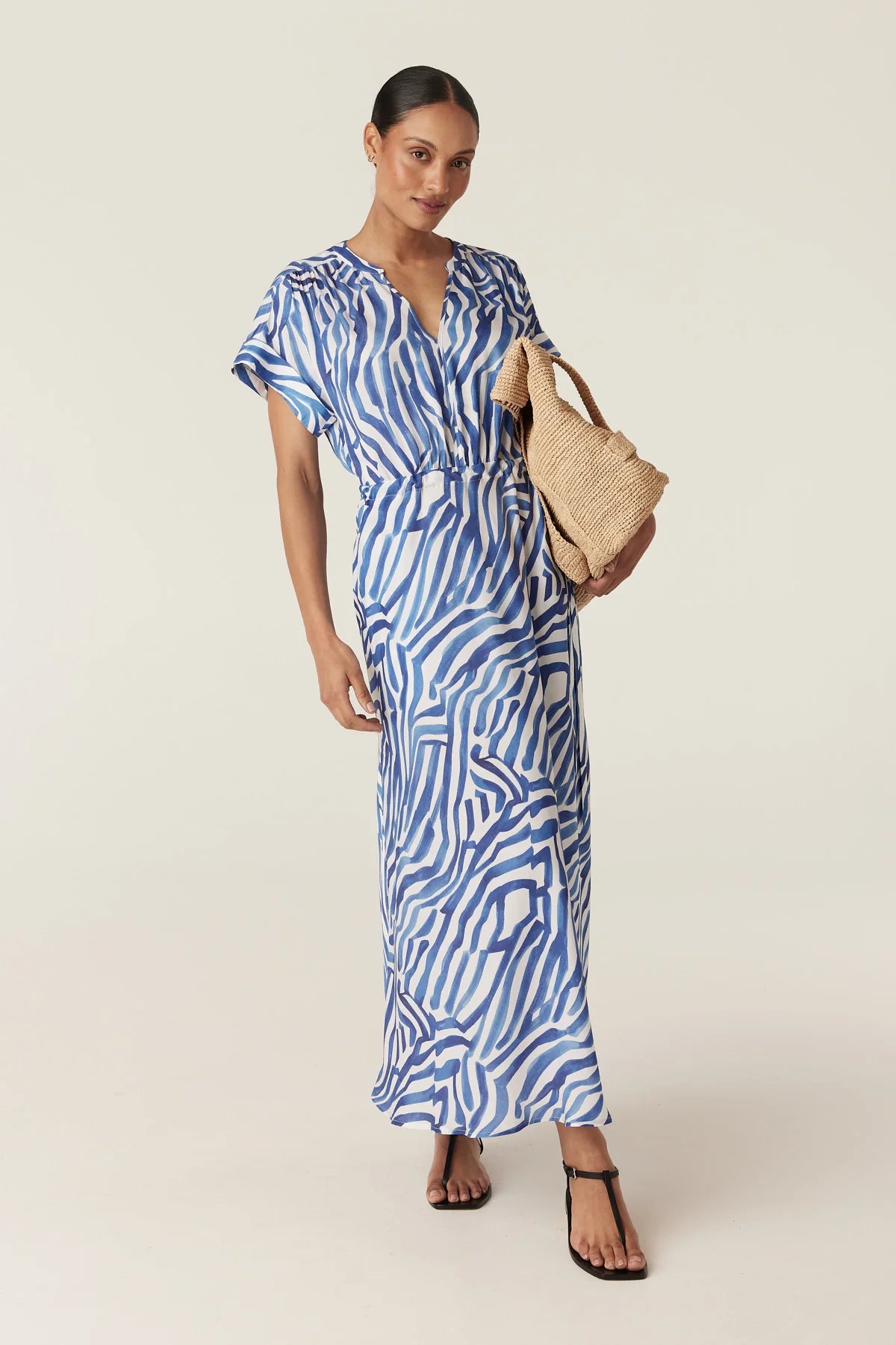 Cable Melbourne Sea Breeze Midi Dress in Blue Wave Print, worn - front with a raffia tote