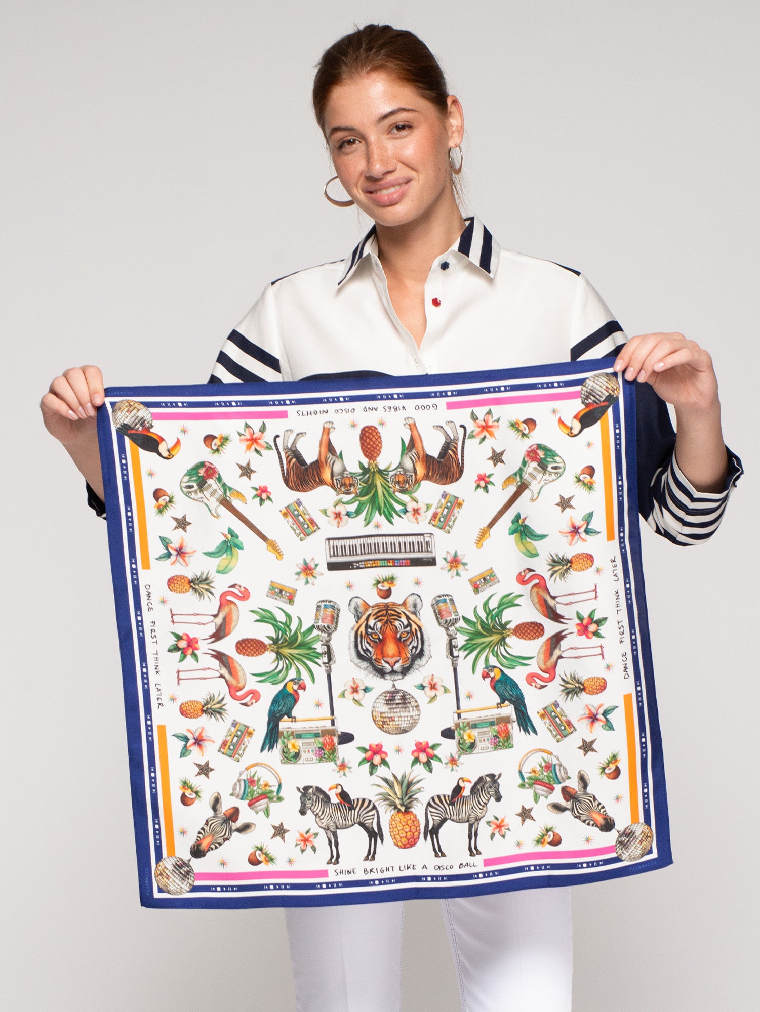 Vilagallo Jungle Disco Medium Silk Scarf held by model, tiger and disco ball tropical print