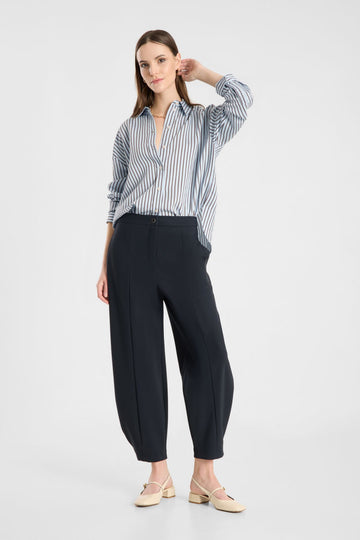 Model wearing Raffaello Rossi Odine Jersey Pant in Navy with a striped shirt, front view